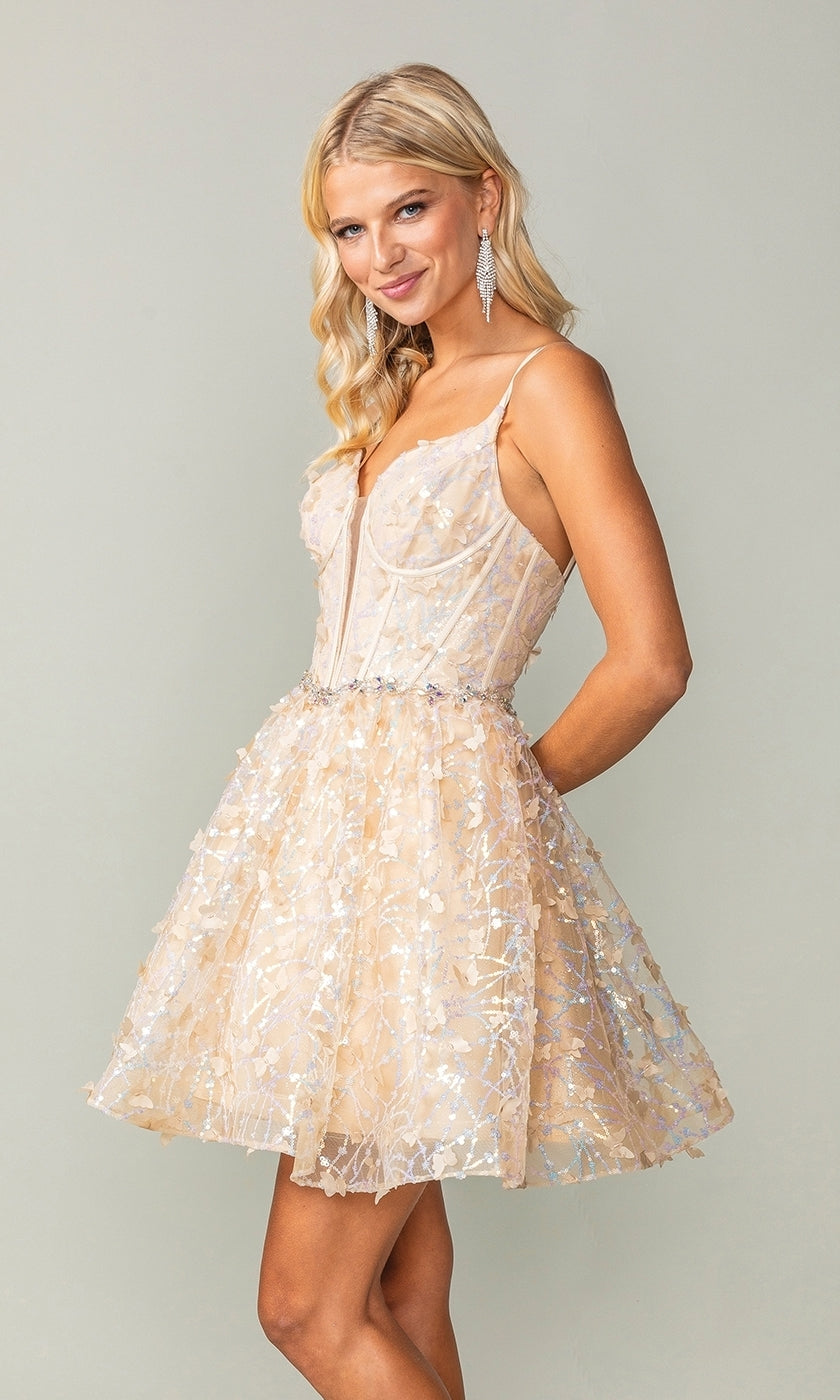 A woman poses against a plain background in the Three-D Short Butterfly Homecoming Dress 3350, a sleeveless light beige party dress with floral patterns and a corset-style bodice.